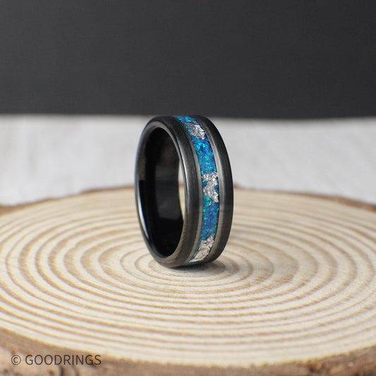 Aquamarine opal tungsten ring with silver leaf inlay. Vibrant blue and green hues reflect ocean beauty, framed by polished silver lines for contrast. Perfect as a wedding band or gift.