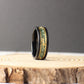 Elegant black tungsten wedding band with a moss agate inlay showcasing natural patterns and gold leaf details. Gold lines frame the inlay, adding sophistication. Comes with a ring box, free ring sizer, and silicone ring, plus lifetime warranty and hassle-free returns.