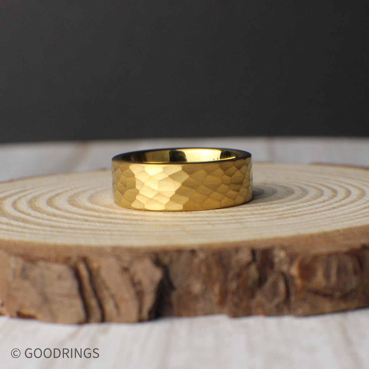 A modern 8mm tungsten ring plated in 18K gold with a hammered finish for added texture and depth. Great for minimalist tastes, the ring offers long-lasting wear and a classic look. Included in the set are a silicone band, ring sizer, and elegant box—perfect for gifting or daily wear. Free exchanges and returns, plus a lifetime warranty, make this a practical yet premium option.