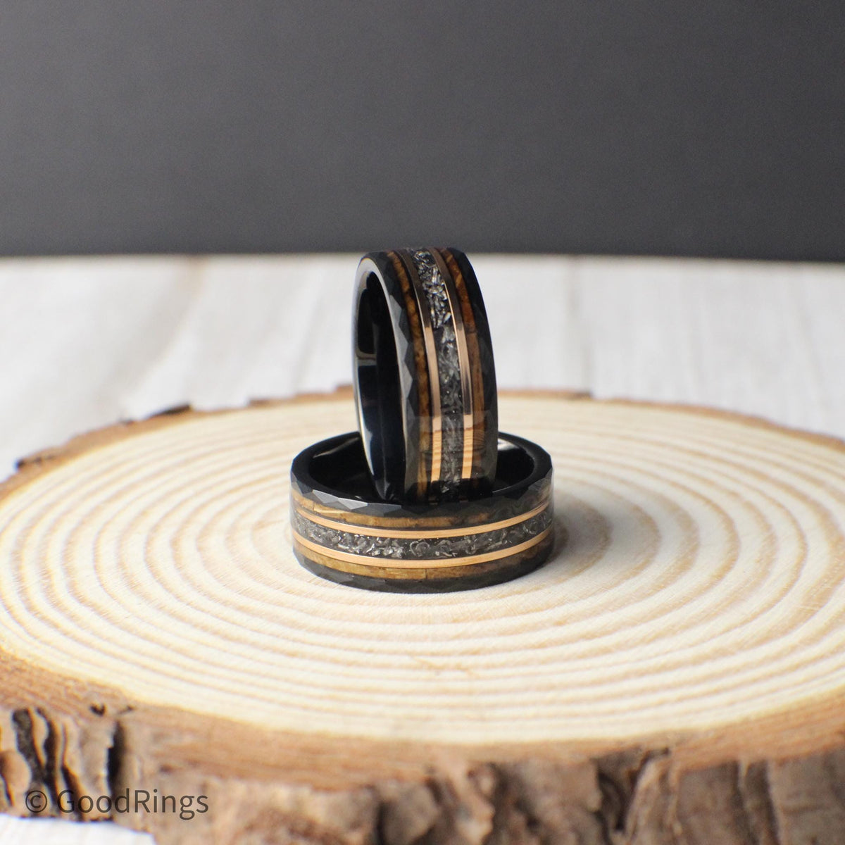 This men’s ring combines black hammered tungsten with a cosmic strip of genuine meteorite, framed by bands of rose gold and whiskey barrel wood. The blend of earthy and celestial elements gives the ring a powerful, distinctive presence. Built for durability and designed with a focus on natural materials, it’s a perfect gift for life’s biggest moments or everyday wear.