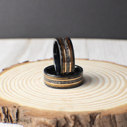This men’s ring combines black hammered tungsten with a cosmic strip of genuine meteorite, framed by bands of rose gold and whiskey barrel wood. The blend of earthy and celestial elements gives the ring a powerful, distinctive presence. Built for durability and designed with a focus on natural materials, it’s a perfect gift for life’s biggest moments or everyday wear.