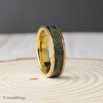 An 8mm or 6mm wide tungsten ring with a hammered gold-plated surface, paired with a dual inlay design. The ring features a warm, textured strip of burnt whiskey barrel wood, complemented by a center line of crushed moss agate for a vibrant, earthy contrast. The hammered texture gives the band a handcrafted, masculine feel, making it a great fit for nature lovers or anyone looking for something unique.