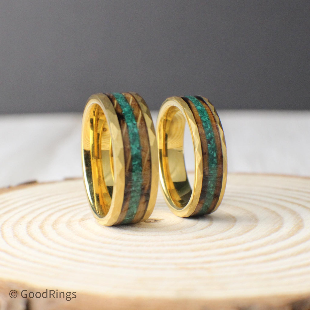 Gold-plated hammered tungsten ring available in 6mm or 8mm widths, inlaid with two striking natural materials. The outer inlay is made from burnt whiskey barrel wood, offering a warm, smoky tone, while the center is lined with crushed moss agate, adding a green, forest-inspired accent. This ring combines rugged durability with refined design for a distinctive, organic look.