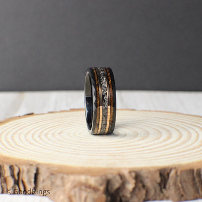 Crafted from strong black tungsten, this ring features a hammered texture and a center inlay of genuine meteorite, highlighted with rose gold stripes and whiskey barrel wood. The unique blend of elements gives the ring a cosmic-meets-rustic look, ideal for men who want a wedding band or everyday accessory with character, strength, and a touch of timeless elegance.