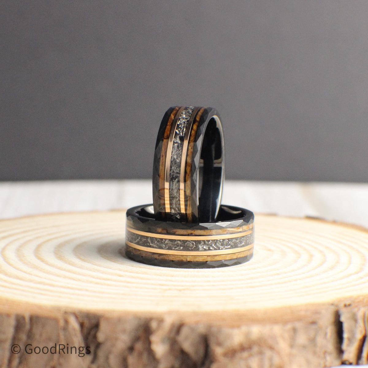 This men’s wedding band is built from hammered black tungsten and accented with a genuine meteorite inlay, framed by warm rose gold and reclaimed whiskey barrel wood. With its strong construction and one-of-a-kind materials, the ring offers a perfect balance of style and substance, making it a thoughtful gift or bold accessory for someone with a love for adventure and craftsmanship.