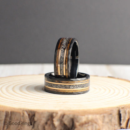 This men’s wedding band is built from hammered black tungsten and accented with a genuine meteorite inlay, framed by warm rose gold and reclaimed whiskey barrel wood. With its strong construction and one-of-a-kind materials, the ring offers a perfect balance of style and substance, making it a thoughtful gift or bold accessory for someone with a love for adventure and craftsmanship.