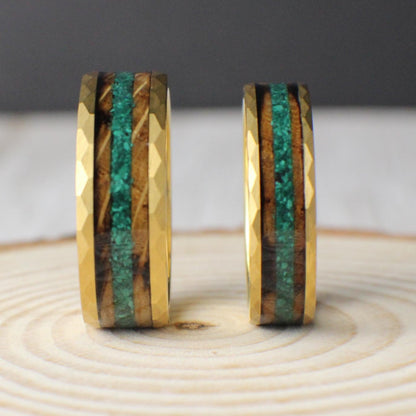 A gold-plated tungsten ring featuring a rugged hammered finish and a unique inlay combination. The inlay includes a rich strip of burnt whiskey barrel wood, paired with a narrow center line of crushed moss agate. The blend of earthy green and warm wood tones makes this ring a standout piece. Available in both 6mm and 8mm widths, it’s designed for durability, style, and a touch of natural character.