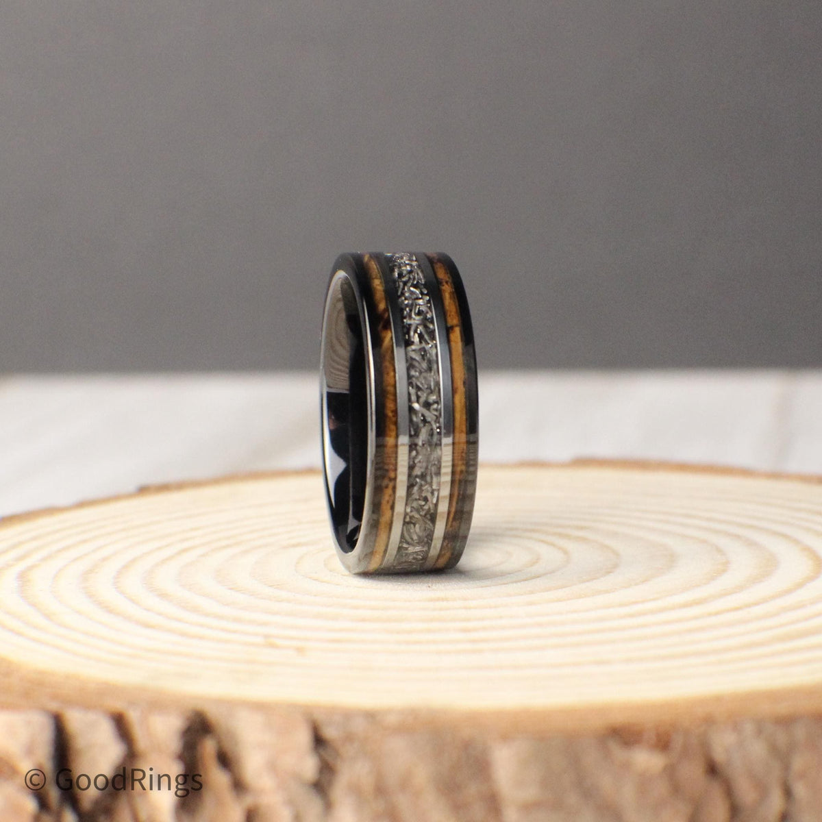 Celebrate your love with an 8mm tungsten ring that combines tradition and individuality. This wedding band features a deep whiskey barrel inlay, with a genuine meteorite stripe running through the center. Framed by silver lines, the meteorite adds a bold contrast that’s both timeless and otherworldly. A perfect choice for wedding, anniversary, or promise rings, this design balances rustic charm with cosmic elegance.