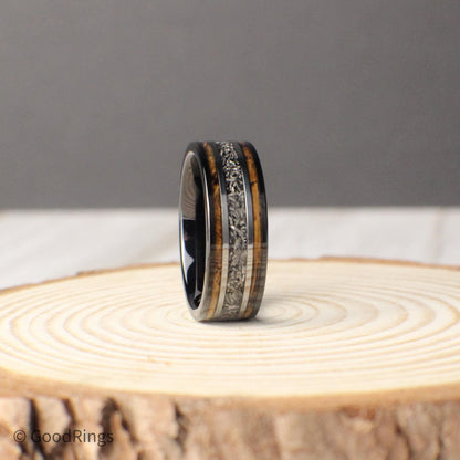 Celebrate your love with an 8mm tungsten ring that combines tradition and individuality. This wedding band features a deep whiskey barrel inlay, with a genuine meteorite stripe running through the center. Framed by silver lines, the meteorite adds a bold contrast that’s both timeless and otherworldly. A perfect choice for wedding, anniversary, or promise rings, this design balances rustic charm with cosmic elegance.