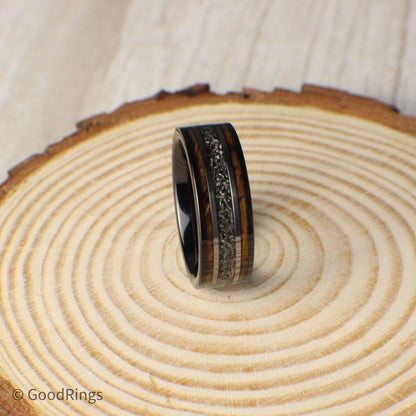 This men's 8mm tungsten ring is designed with commitment in mind. It features an inlay of burnt whiskey barrel wood, intersected by a center line of real meteorite. Silver lines frame the meteorite, adding structure and contrast. Ideal as a wedding ring, promise ring, or anniversary gift, this band represents strength, passion, and the beauty of natural elements—perfect for marking a meaningful chapter.
