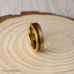 A detailed shot of the 6mm gold tungsten wedding band showing its brushed matte surface and contrasting organic wood inlay. The ring’s subtle sheen and natural materials make it a standout piece for men who want something unique and durable.