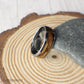 A men’s ring made from durable tungsten and lined with real reclaimed whiskey barrel wood. The domed shape provides a traditional look while the organic wood texture gives it rustic appeal. Perfect for everyday wear or a one-of-a-kind wedding band.