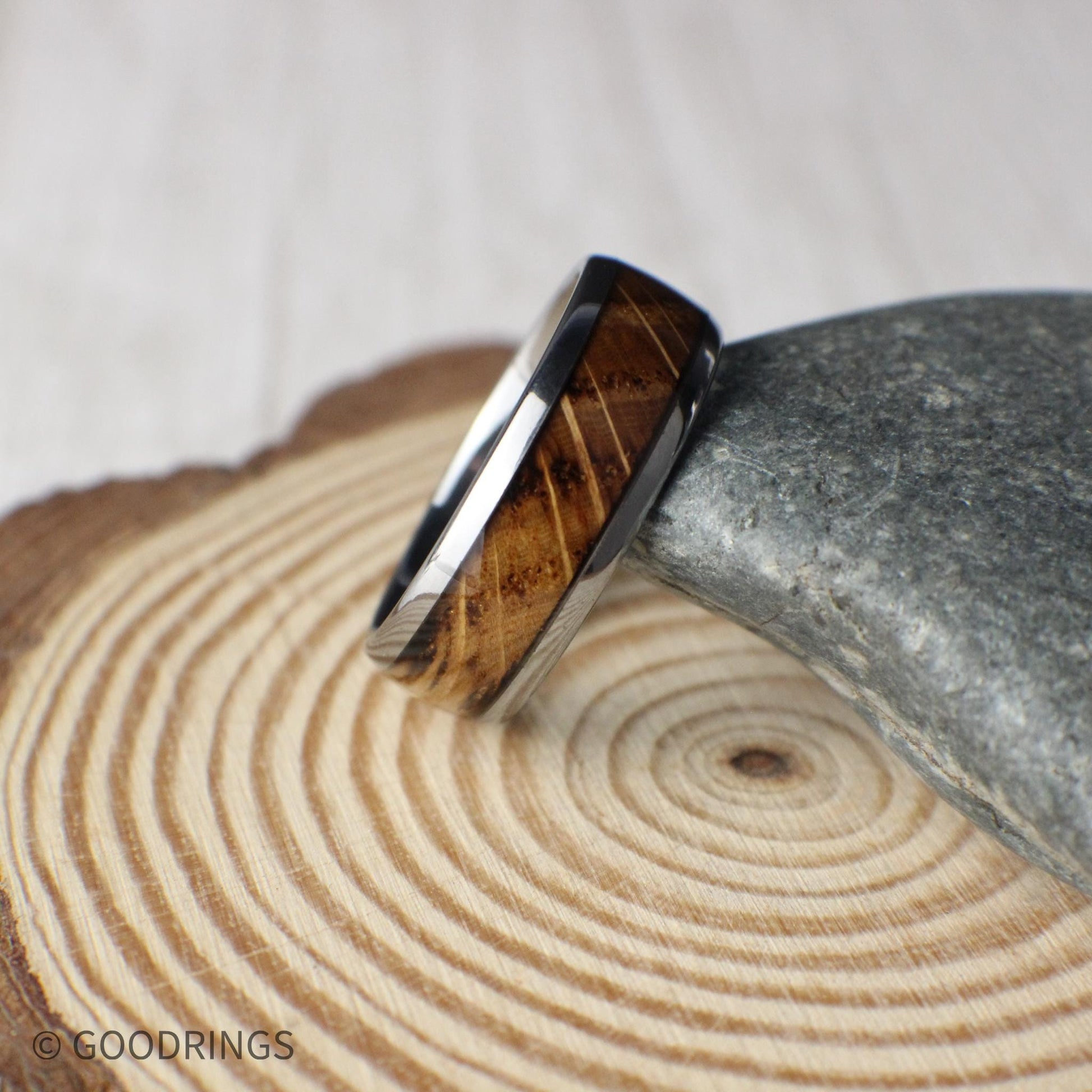A men’s tungsten wedding ring featuring real whiskey barrel wood inlay and a domed profile. The polished edges and smooth curvature give the band a timeless shape, while the rustic wood adds warmth and heritage. Designed for comfort, strength, and everyday wear.