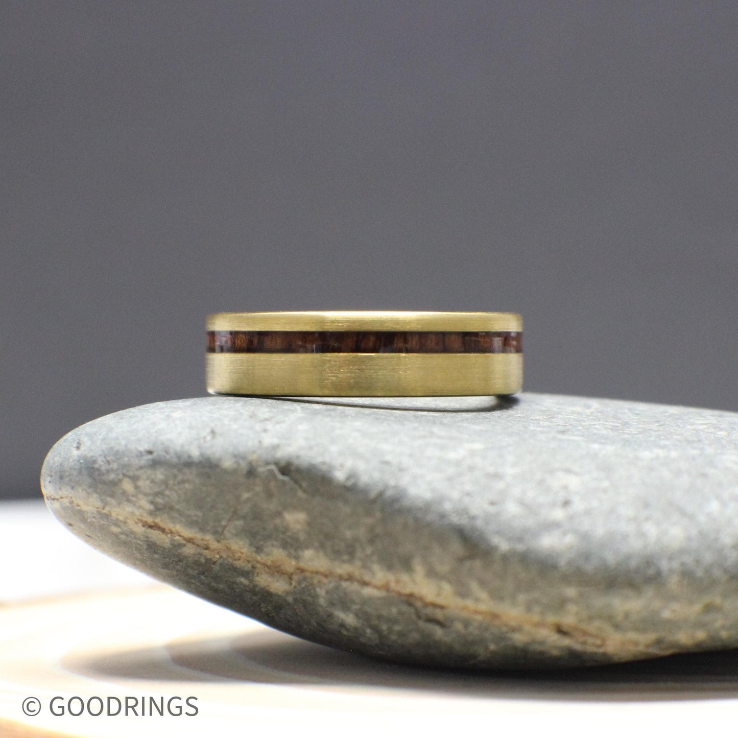 This men’s ring is crafted with a brushed gold tungsten exterior and a deep, warm inlay of Hawaiian Koa wood. Sleek and masculine, it blends tradition and modern style into one solid 6mm-wide band with a comfort fit interior.