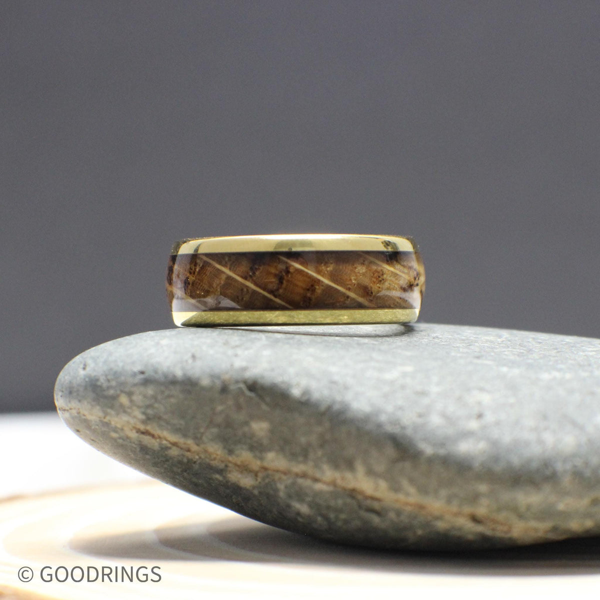 This rustic gold ring for men features a genuine whiskey barrel wood inlay with high-polish gold tungsten edges. The warm tones and smooth domed shape make it an ideal wedding band or everyday accessory with real personality and durability.