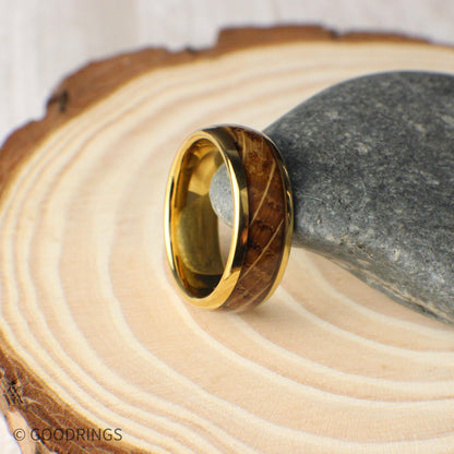 Close-up view of a domed gold men’s ring made from tungsten and whiskey barrel wood. The 8mm band highlights the beauty of the reclaimed wood with natural textures and earthy hues, sealed in a high-gloss finish that protects and shines.