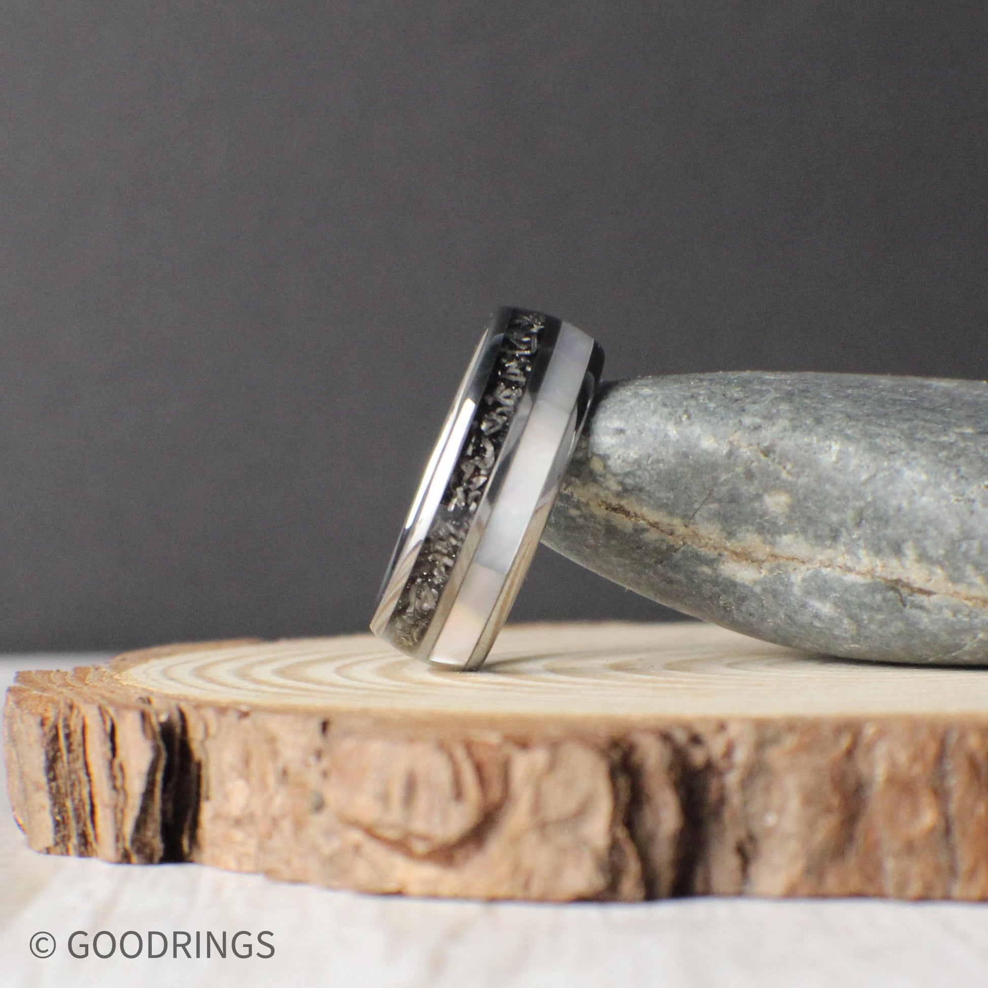 A domed tungsten comfort fit wedding band featuring genuine meteorite and moonstone inlays, designed for durability and style. Includes free returns, free size exchanges, and a limited lifetime warranty with every purchase. Comes in a premium green GoodRings gift box and ships fast.