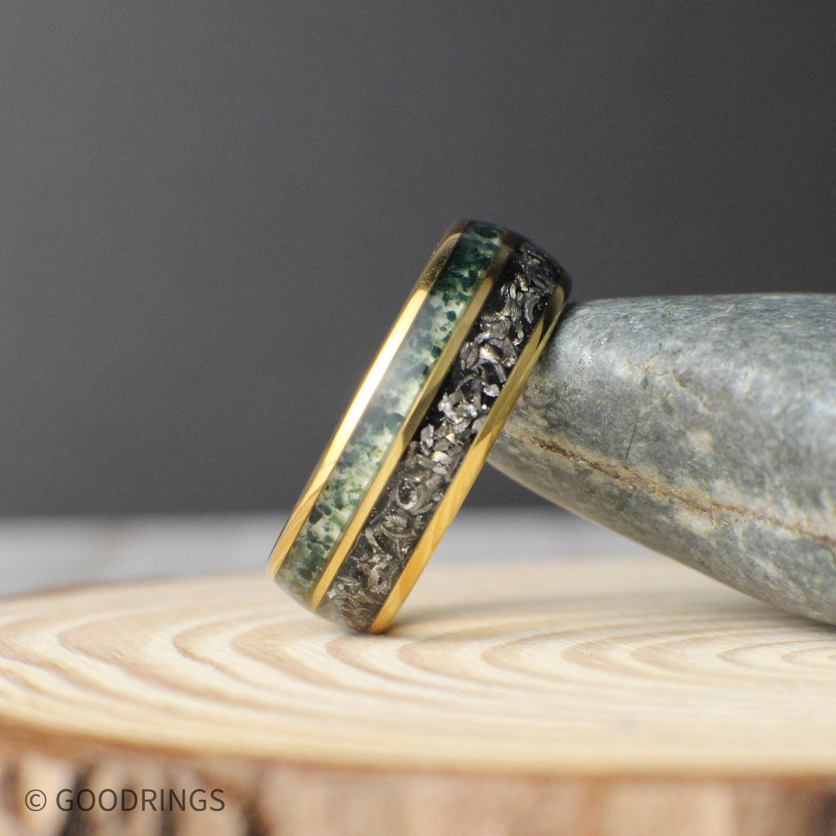 A unique men’s anniversary band made with real meteorite and moss agate inlays inside a gold domed tungsten frame.