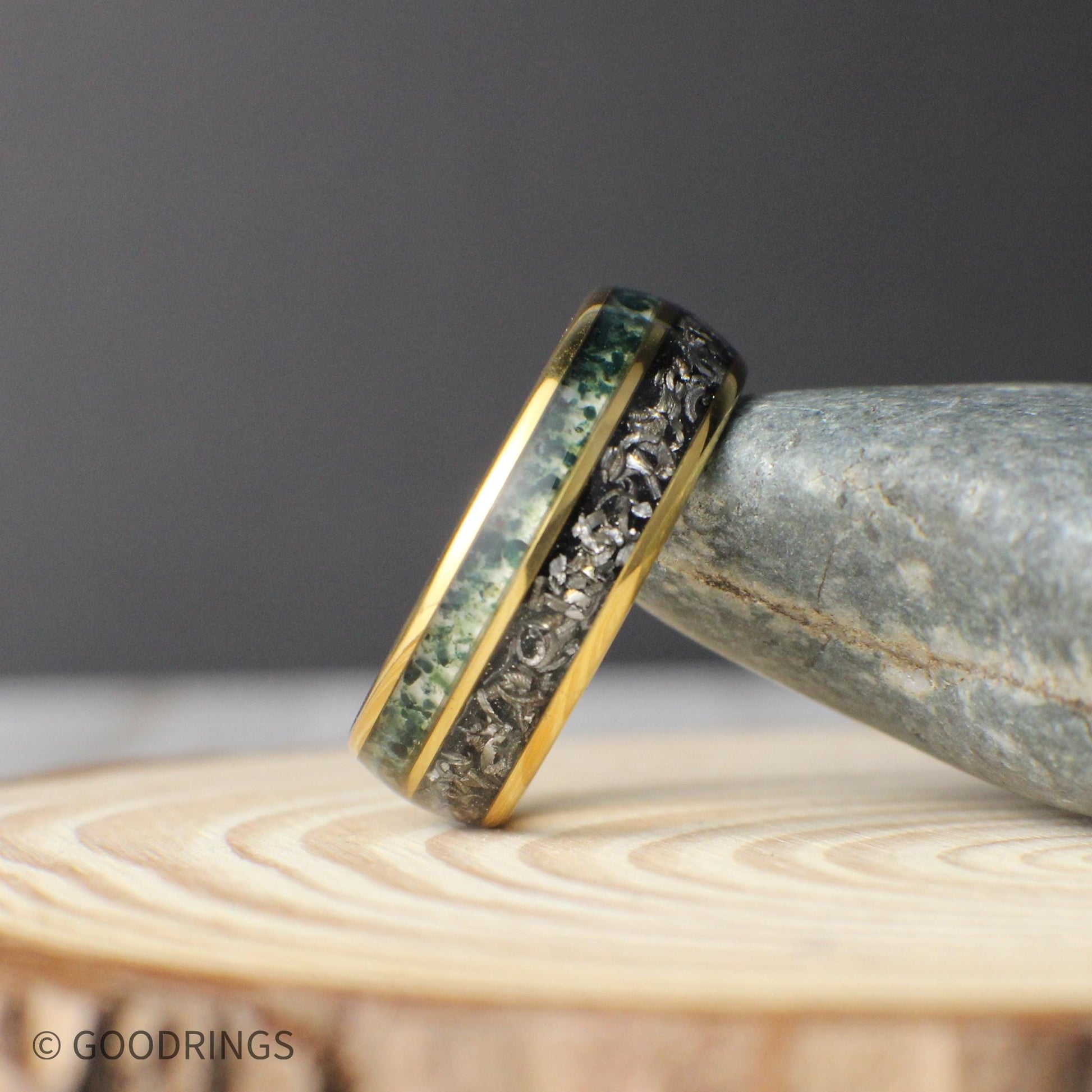 A unique men’s anniversary band made with real meteorite and moss agate inlays inside a gold domed tungsten frame.
