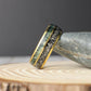 A unique men’s anniversary band made with real meteorite and moss agate inlays inside a gold domed tungsten frame.