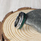 Premium tungsten wedding band with striking crushed malachite and sleek moonstone inlays. The rich green tones of malachite represent growth and renewal, while the luminous moonstone adds balance and elegance. The domed profile offers a classic shape, while the comfort-fit interior ensures long-lasting wear. A unique, durable, and stylish ring choice for weddings, anniversaries, or everyday wear.