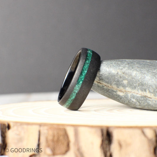 A modern men’s wedding band made of sandblasted domed tungsten with a striking offset inlay of genuine green malachite, symbolizing strength, growth, and individuality. This durable and unique malachite ring blends rugged tungsten with the natural beauty of stone, perfect as a wedding band, promise ring, or anniversary gift.