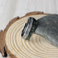 Elegant tungsten wedding band with crushed moss agate and shimmering moonstone accents. The natural green textures of moss agate create a calming, earthy feel, beautifully contrasted by the luminous moonstone. Domed for a classic shape and built with a comfort-fit interior, this scratch-resistant tungsten ring combines strength with elegance, making it perfect for weddings, anniversaries, or special occasions.