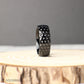 Black titanium ring with dimpled golf ball pattern, 8mm wide comfort fit band designed for long-lasting wear, photographed to show off its bold, masculine look, making it an ideal gift for golfers, anniversaries, or as a one-of-a-kind wedding ring that blends modern design with personal style.