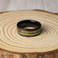 Unique hammered tungsten ring in black, measuring 8mm wide with an eye-catching inlay combination of moss agate, 18K rose gold, and whiskey barrel wood. Each element adds depth and meaning—the moss agate symbolizes growth, the rose gold conveys warmth, and the whiskey barrel wood reflects history and tradition. Strong, stylish, and meaningful, this ring makes a statement for weddings or special milestones.