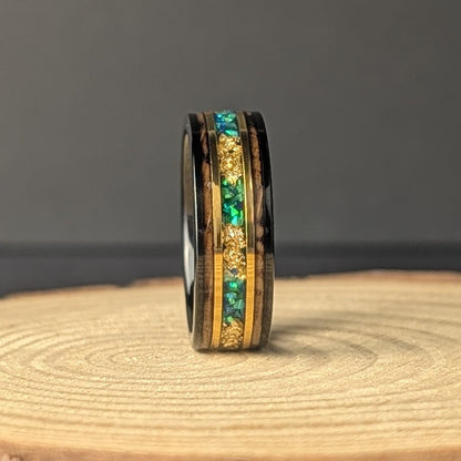Men’s 8mm tungsten wedding band with green opal inlay, whiskey barrel wood interior, and thin 18K gold accents