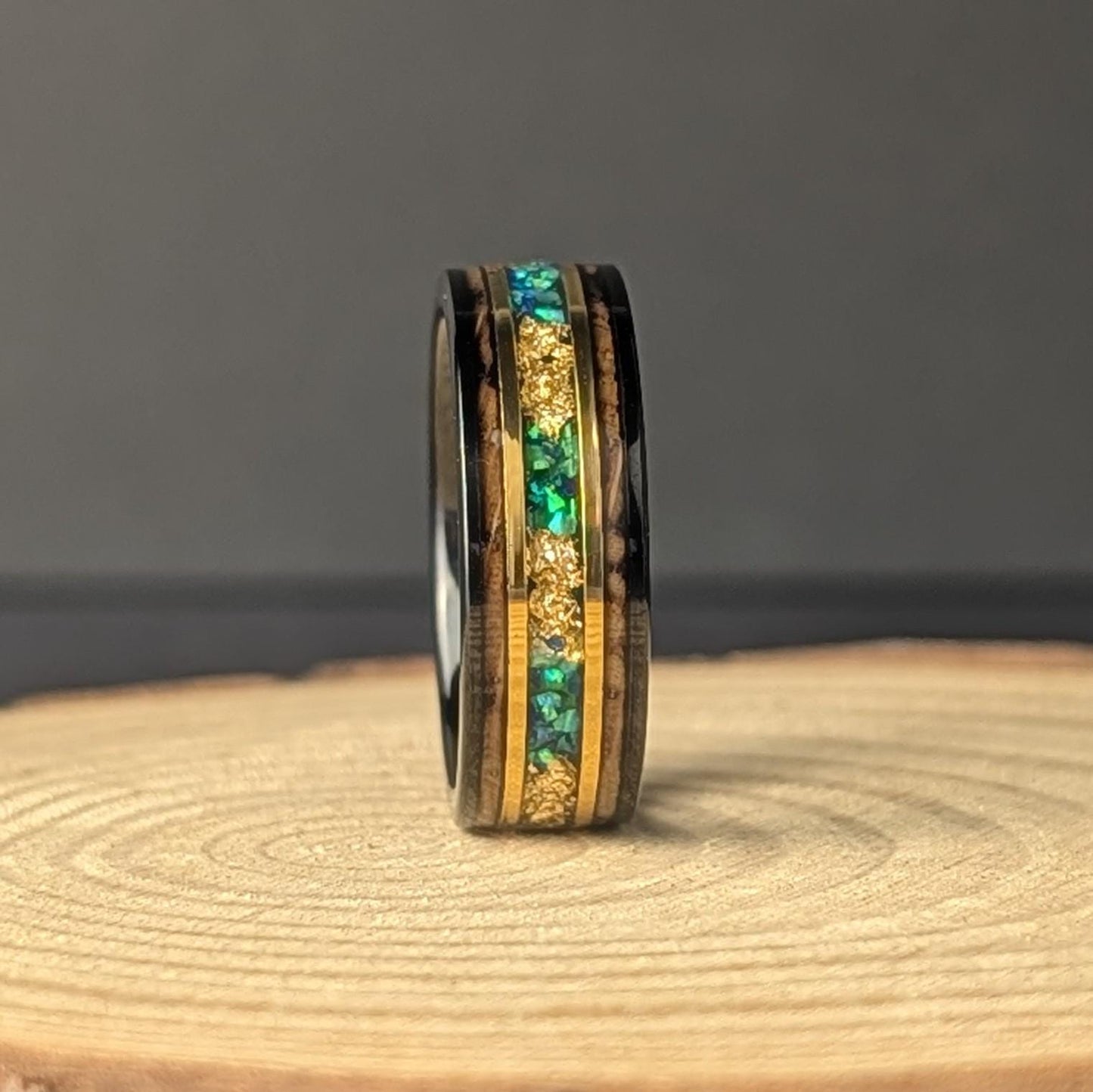 Men’s 8mm tungsten wedding band with green opal inlay, whiskey barrel wood interior, and thin 18K gold accents