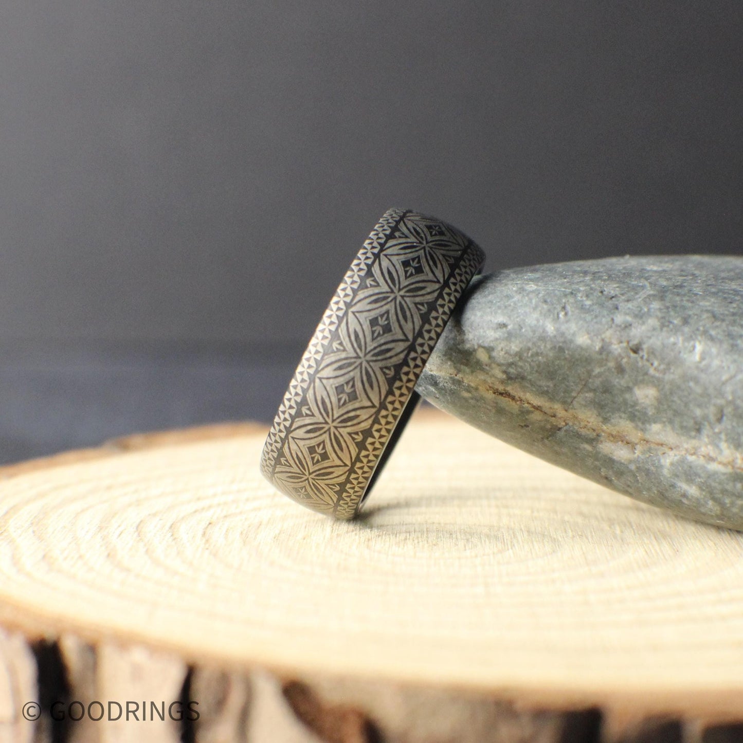 Lifestyle product image of a durable tungsten wedding band designed for daily wear including work outdoor activity and gym use. The engraved Polynesian motif provides symbolic meaning while remaining comfortable and low profile.