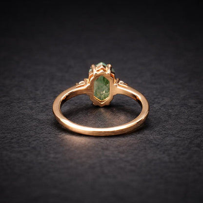 Back view of a moss agate promise ring on a black background.