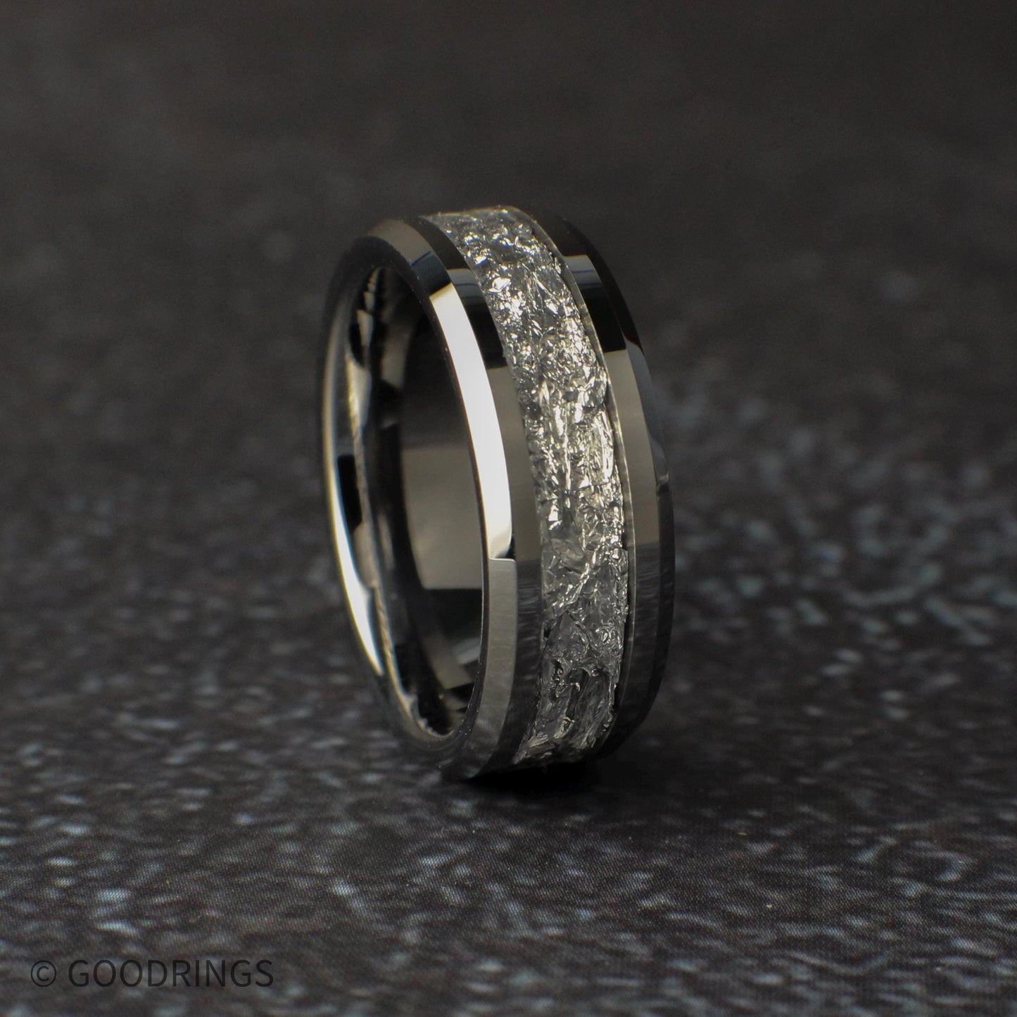 Mens wedding ring on a dark surface