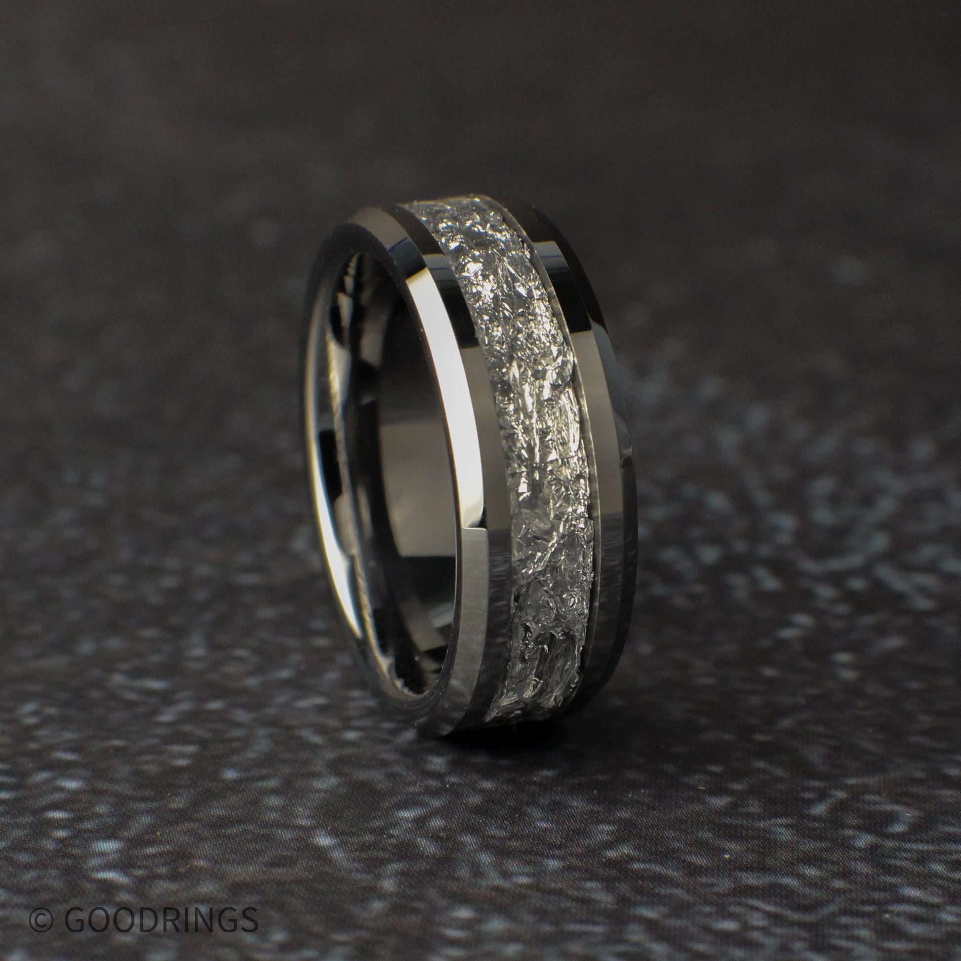 Mens wedding ring on a dark surface
