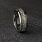 Mens wedding ring on a dark surface