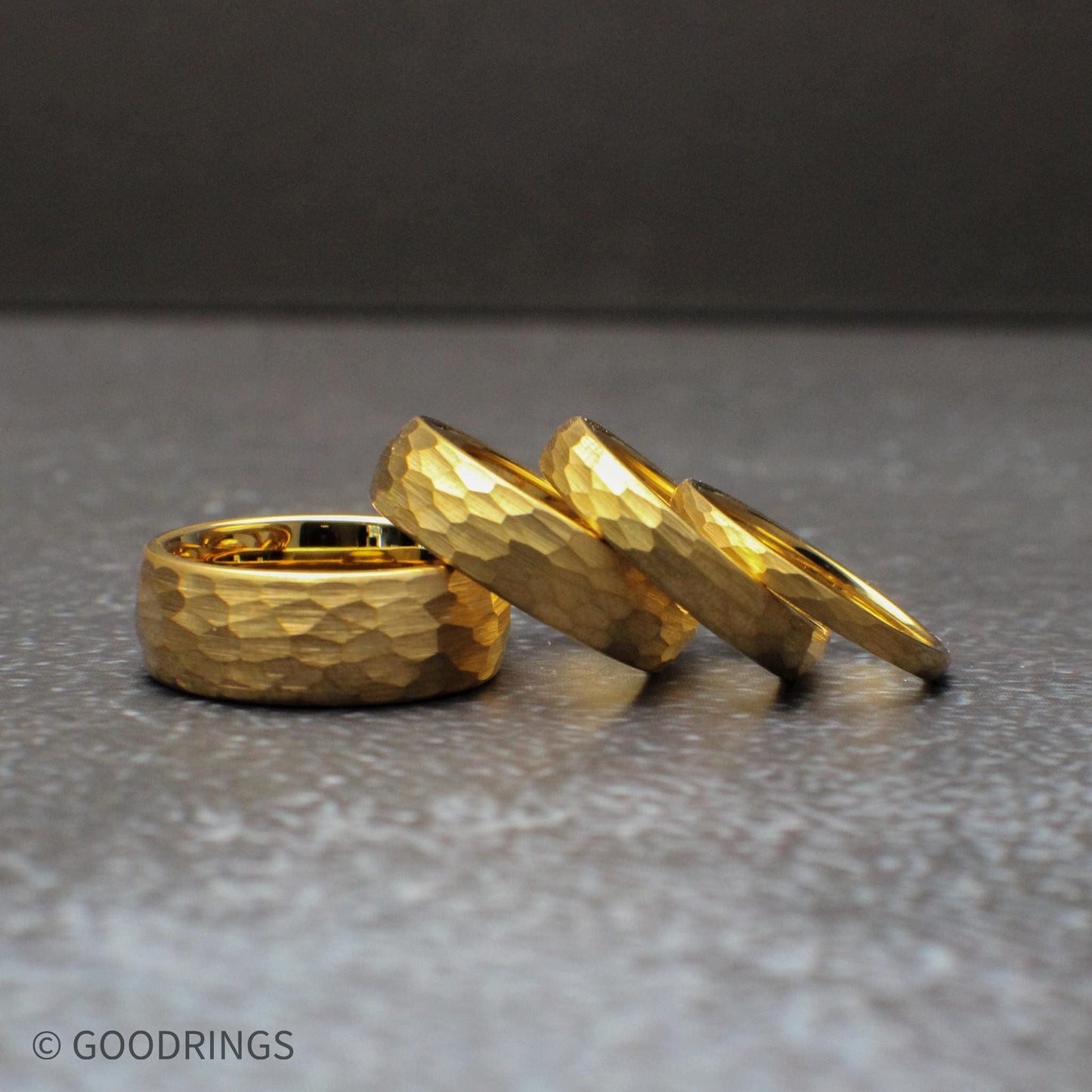 Hammered gold wedding band made from tungsten with a comfort fit interior and domed design. The 18K gold plating gives a rich, warm tone while the hammered texture adds depth and uniqueness, making it ideal for a modern men’s wedding ring, women’s band, or anniversary gift.