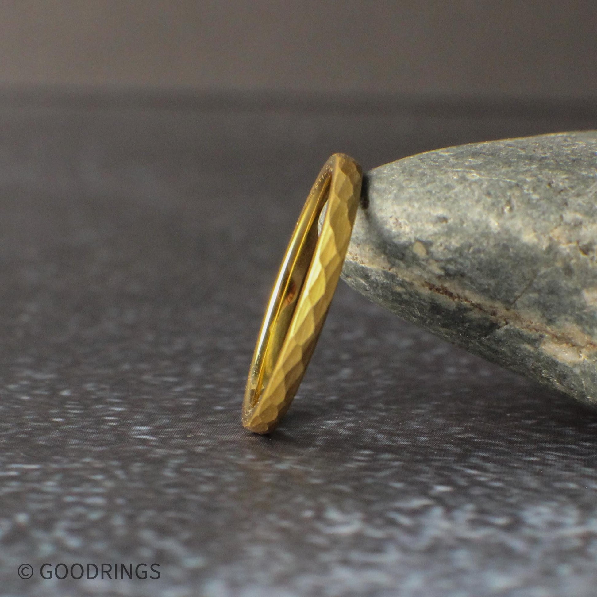 Thin hammered gold tungsten ring in 2mm width featuring a delicate, minimalist design with textured detailing. This domed gold band is perfect for stacking, women’s wedding bands, or those who prefer a subtle and elegant gold ring with a unique hammered finish.