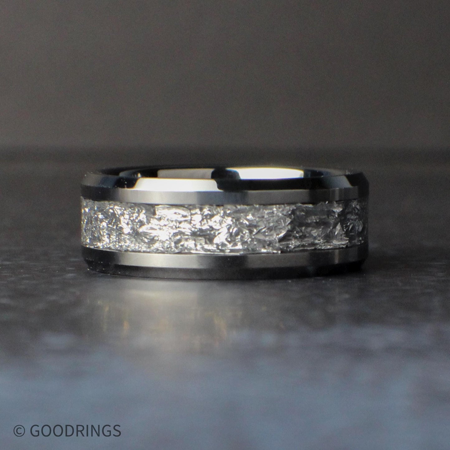 Silver wedding band laying down flat