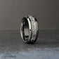 Silver wedding band standing vertically