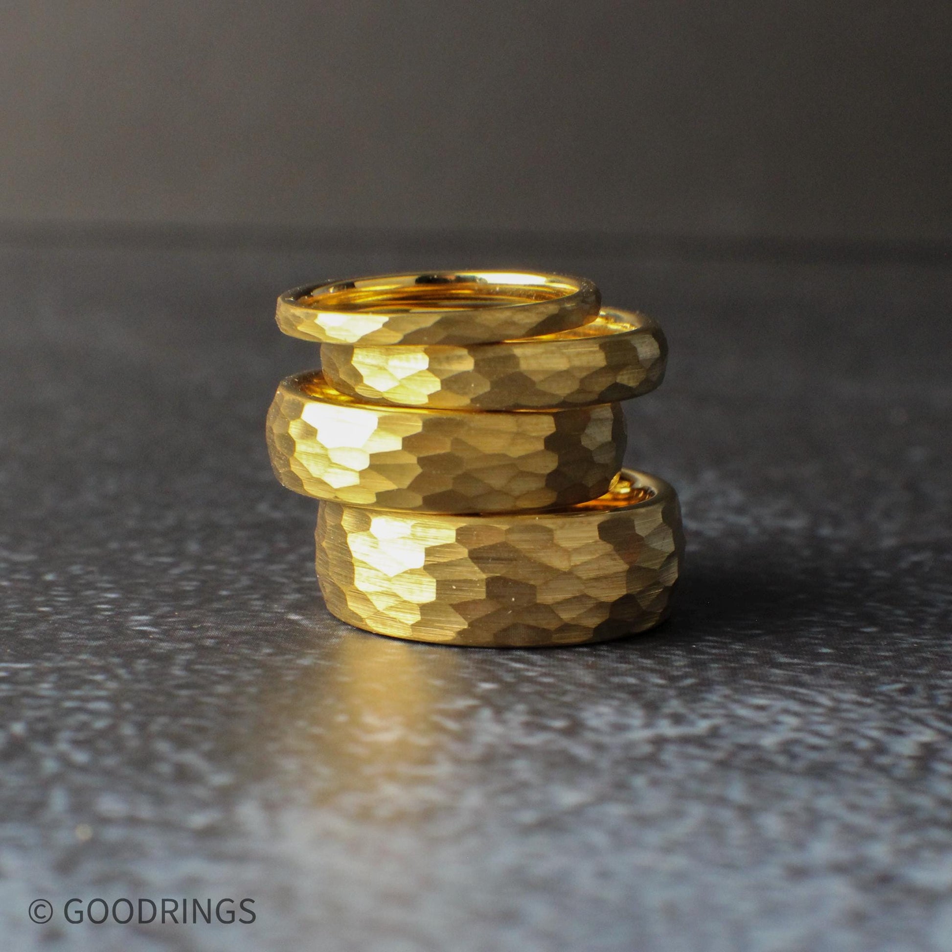Gold tungsten wedding band with hammered finish and domed shape, designed for comfort and durability. The textured gold surface gives a handcrafted look while maintaining a clean, minimalist style suitable for both men and women.