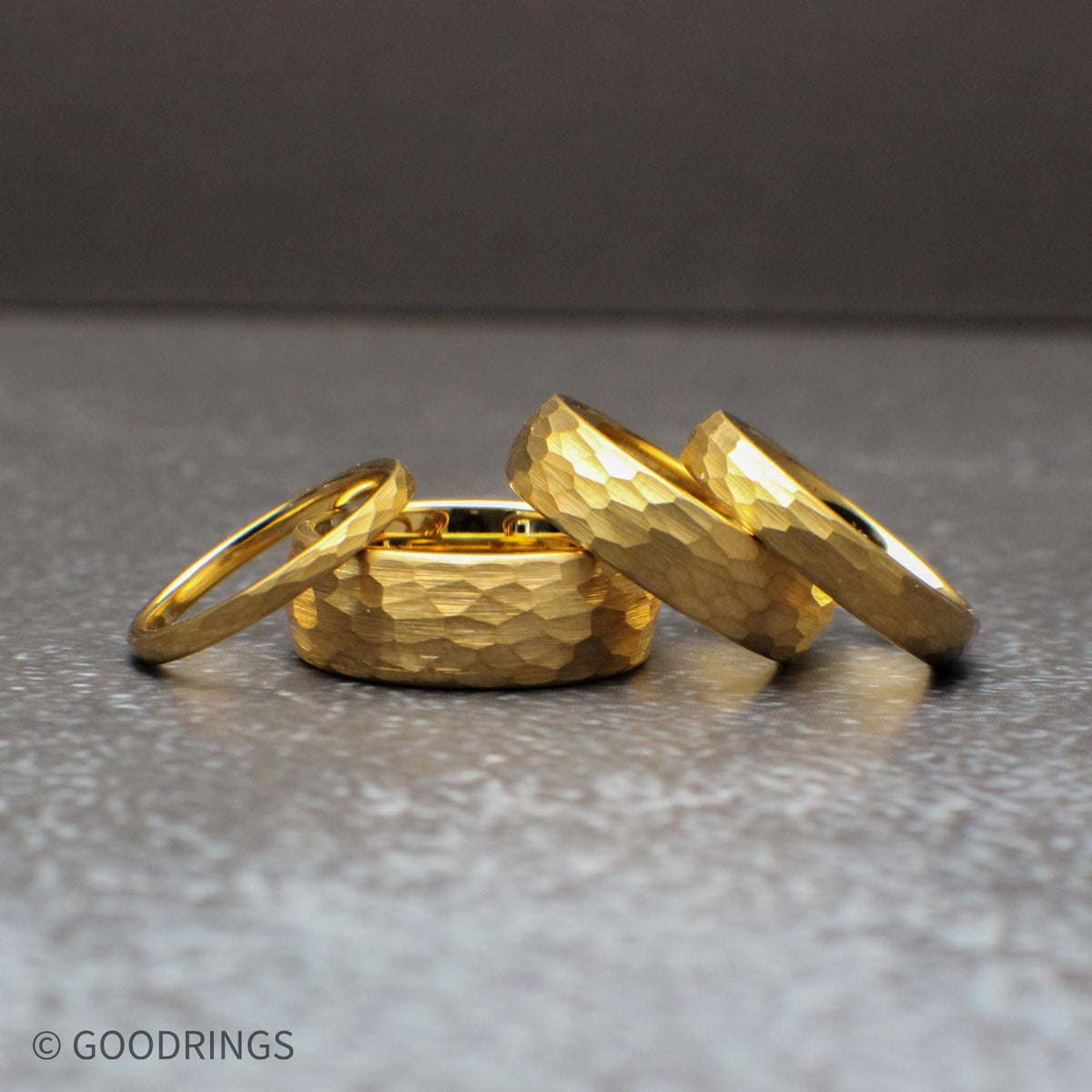 Hammered gold tungsten ring set in multiple widths including 8mm, 6mm, 4mm, and 2mm, featuring a domed profile and textured surface that reflects light beautifully. This 18K gold plated wedding band offers a durable tungsten core with a modern yet timeless look, perfect for men’s and women’s wedding bands, minimalist jewelry lovers, and matching couple ring sets.