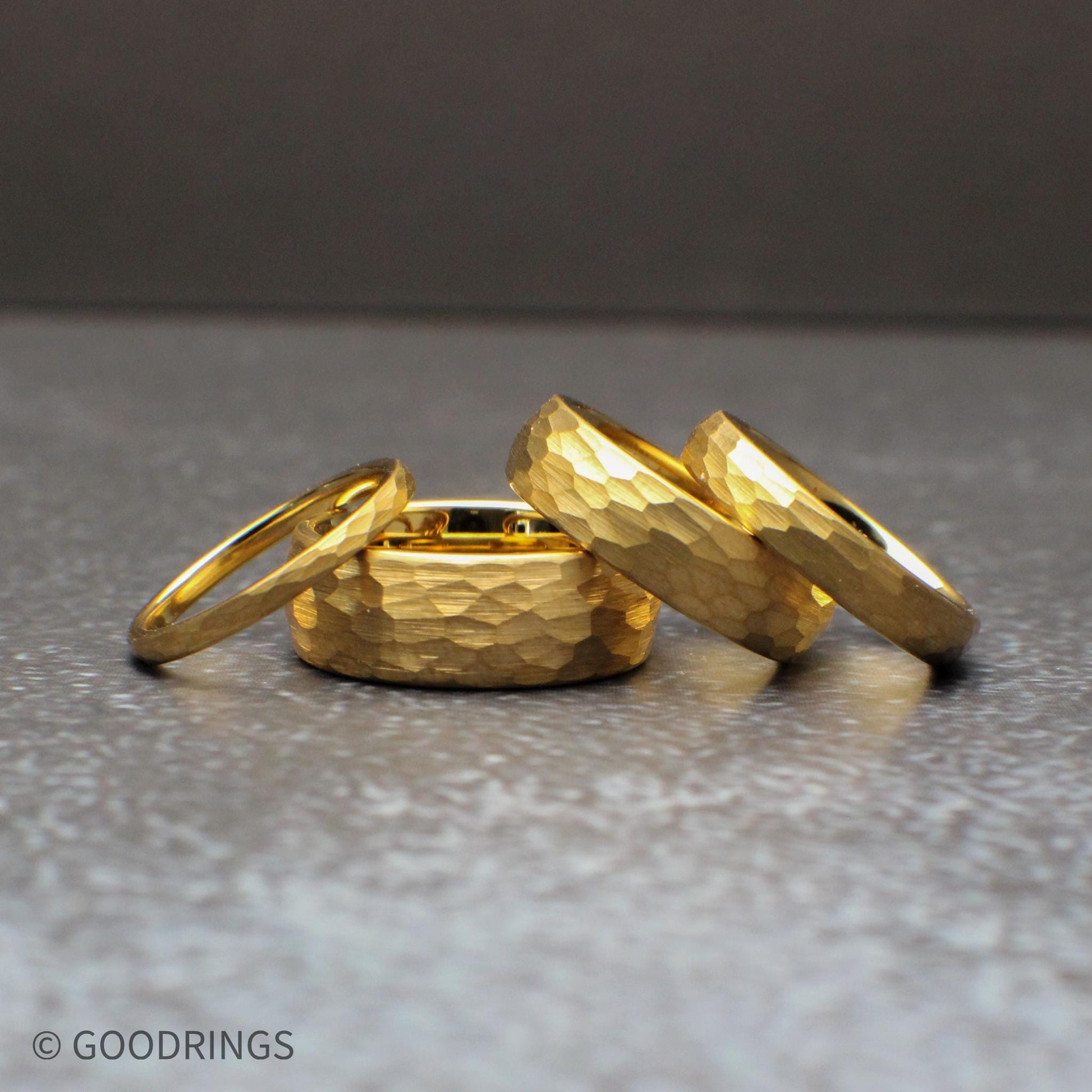 Hammered gold tungsten ring set in multiple widths including 8mm, 6mm, 4mm, and 2mm, featuring a domed profile and textured surface that reflects light beautifully. This 18K gold plated wedding band offers a durable tungsten core with a modern yet timeless look, perfect for men’s and women’s wedding bands, minimalist jewelry lovers, and matching couple ring sets.
