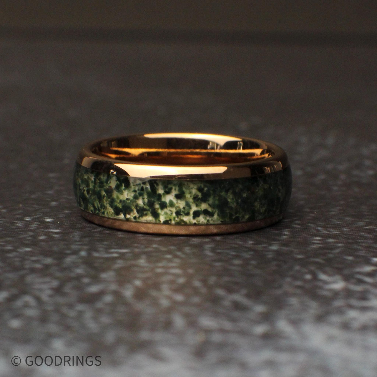 8mm wide moss agate ring laying flat