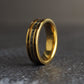 A gold wedding band angled to the left