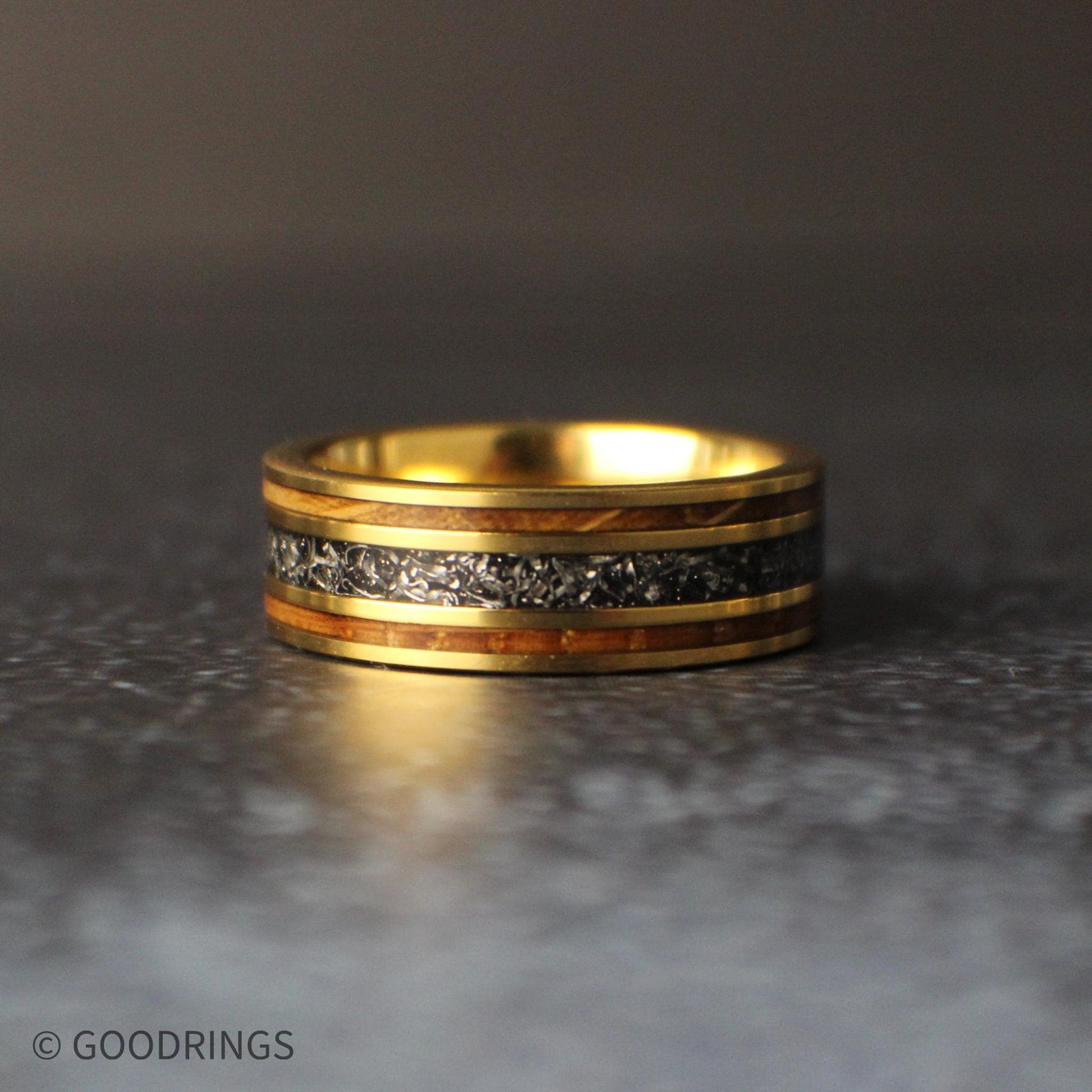 Ring laying flat with light reflecting off of the left hand side.