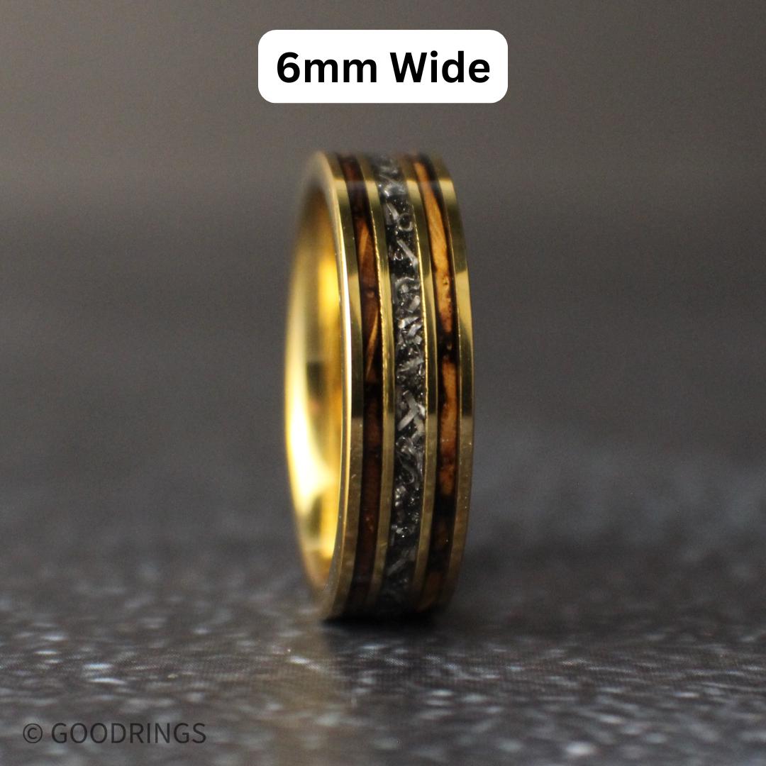 A mens gold wedding ring standing straight up with text above it saying "6mm wide"