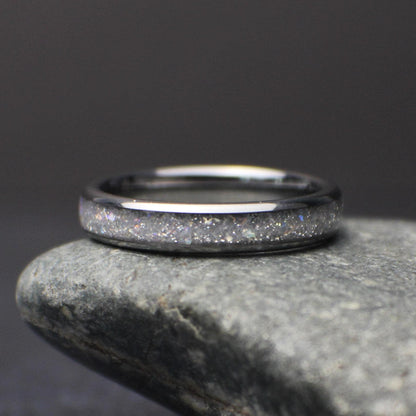 top view of minimalist 4mm moonstone band resting on stone highlighting subtle shimmer and comfort fit design