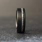 8mm black tungsten wedding band with brushed matte finish and silver leaf inlay channel, photographed on a dark background.
