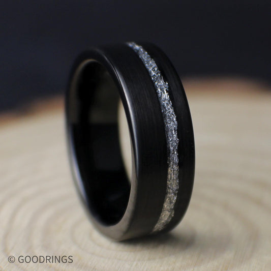 Angled close-up of an 8mm black tungsten men’s ring showing its brushed finish, comfort fit interior, and silver leaf inlay.